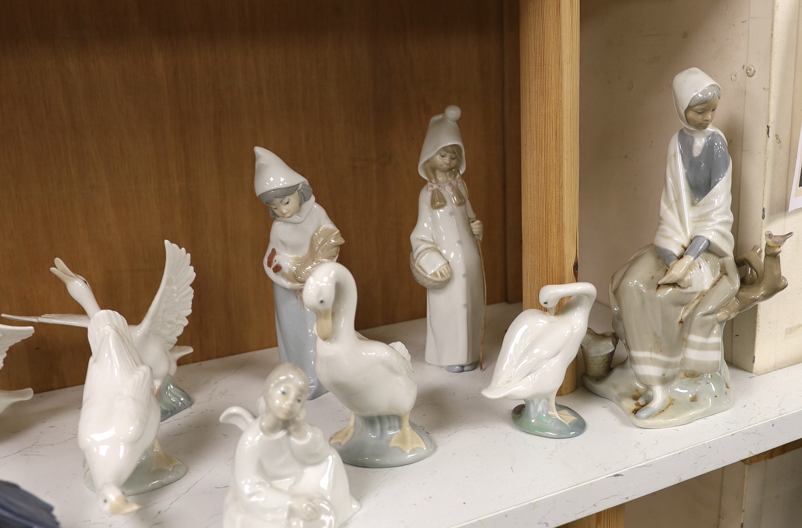 Twenty pieces of Lladro and Nao porcelain, tallest 31cm